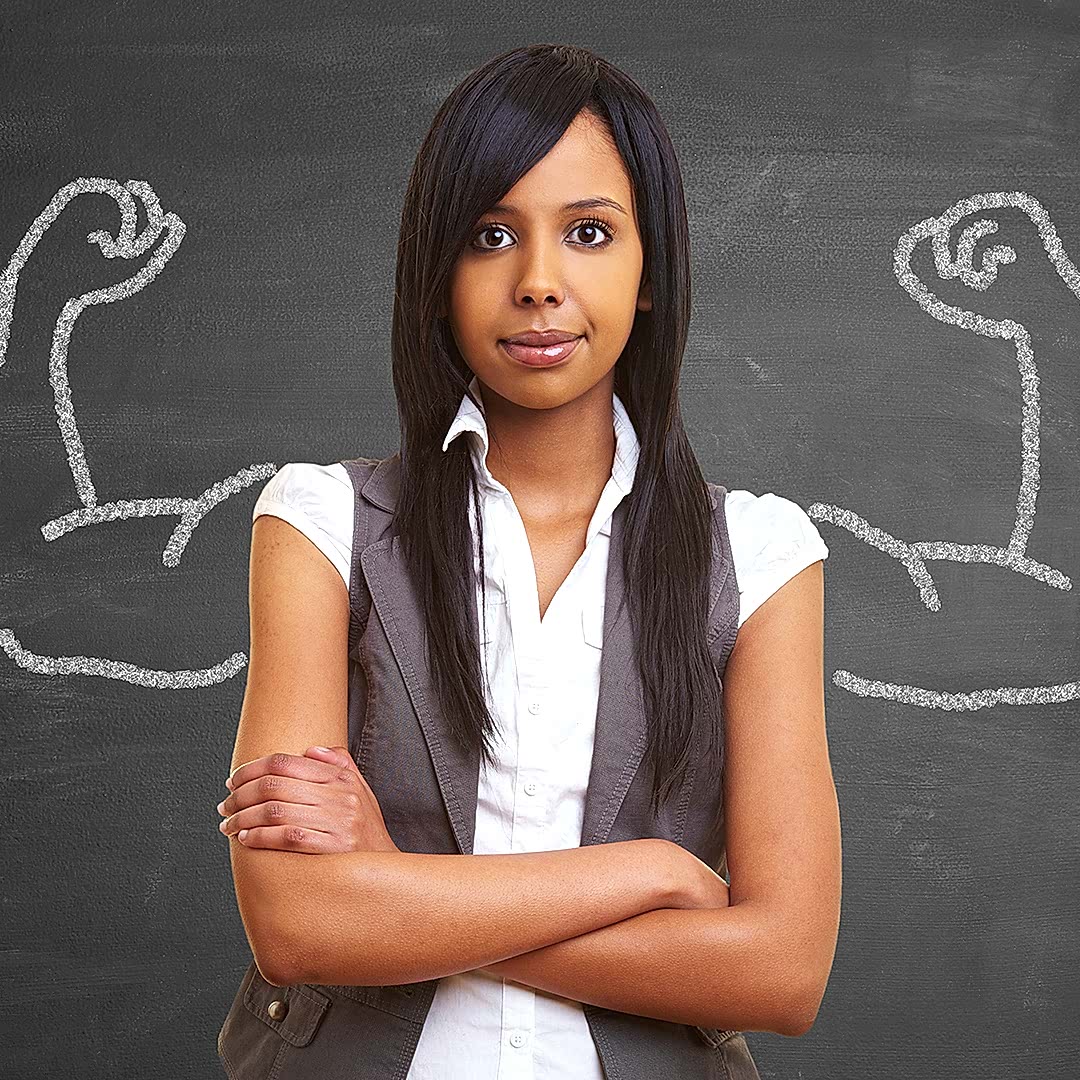 Image of a woman standing cross armed infront of a drawing a arms with big muscles