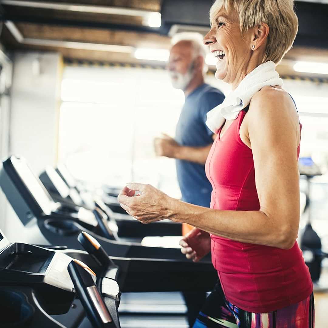 older woman walking on treadmill