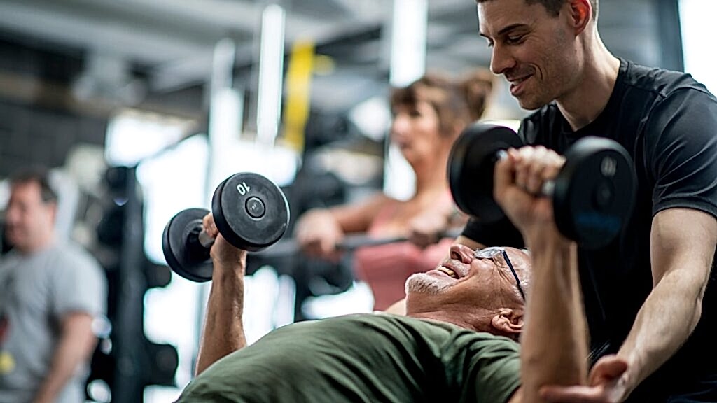 personal trainer working with student