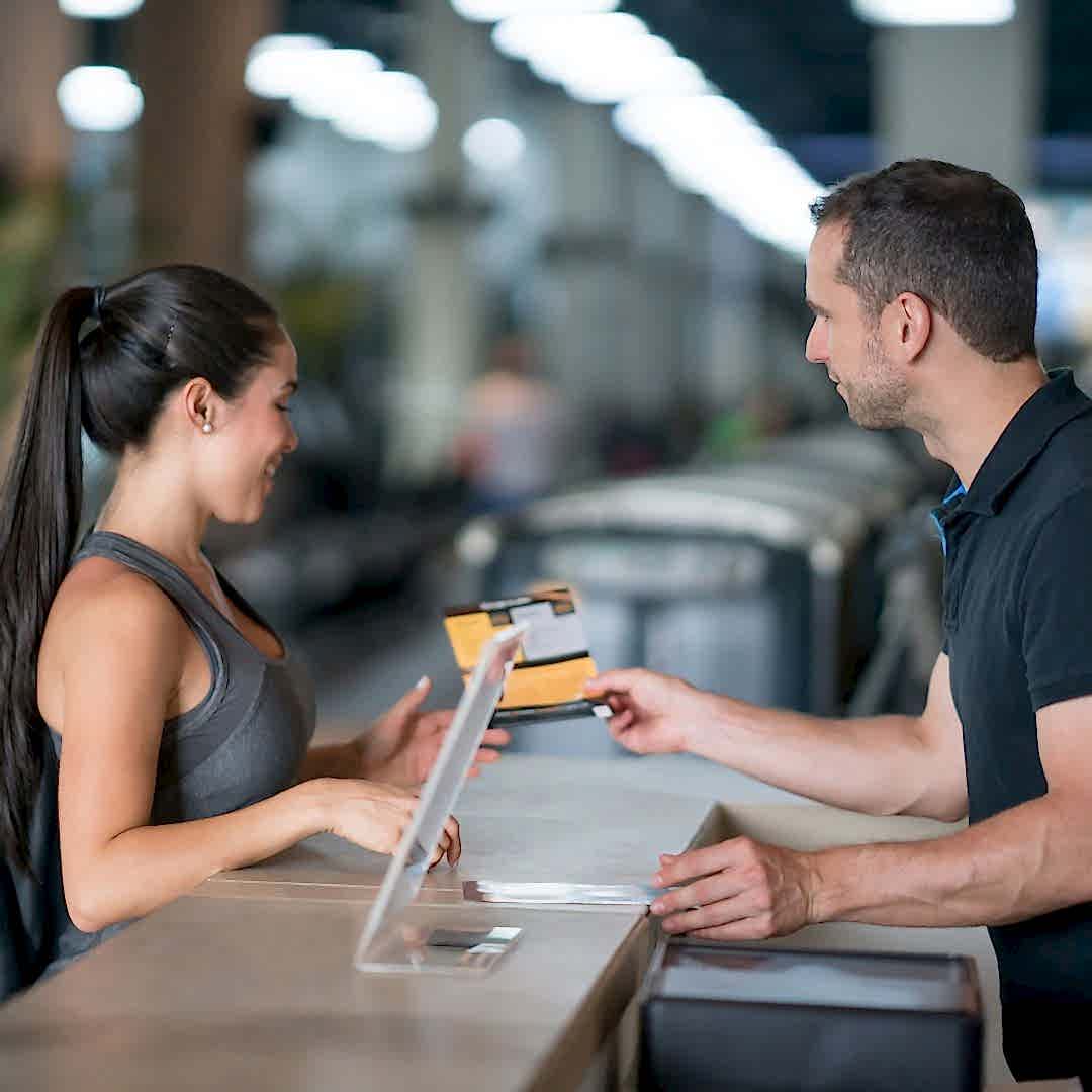 gym staff member with customer