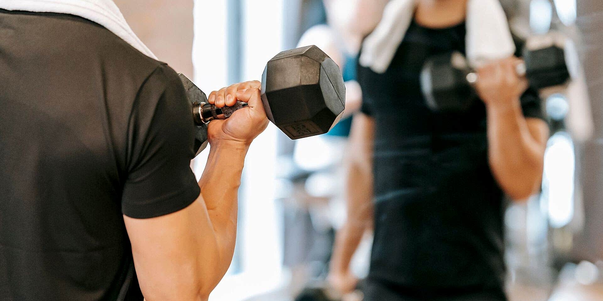 man lifting weights at gym